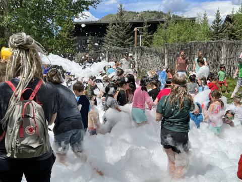 Kids enjoy foam party in the library backyard.