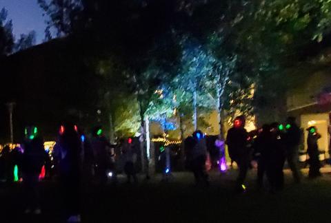 People dancing outside on a lawn, wearing Silent Disco heaphones