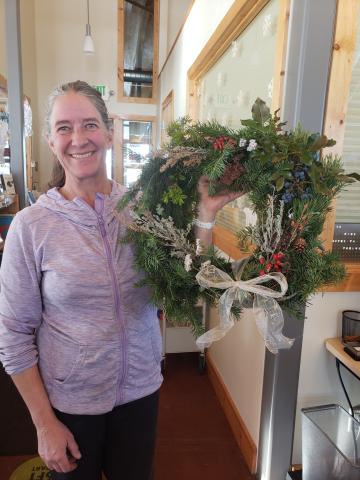 Woman holding an evergreen wreath