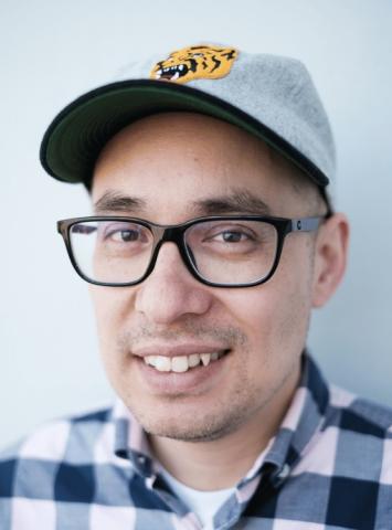 Photo portrait of Jonathan Hill wearing a beasball cap