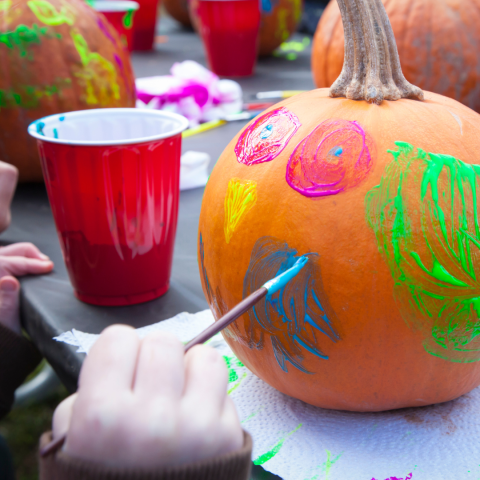 image of a pumpking being painted by a child