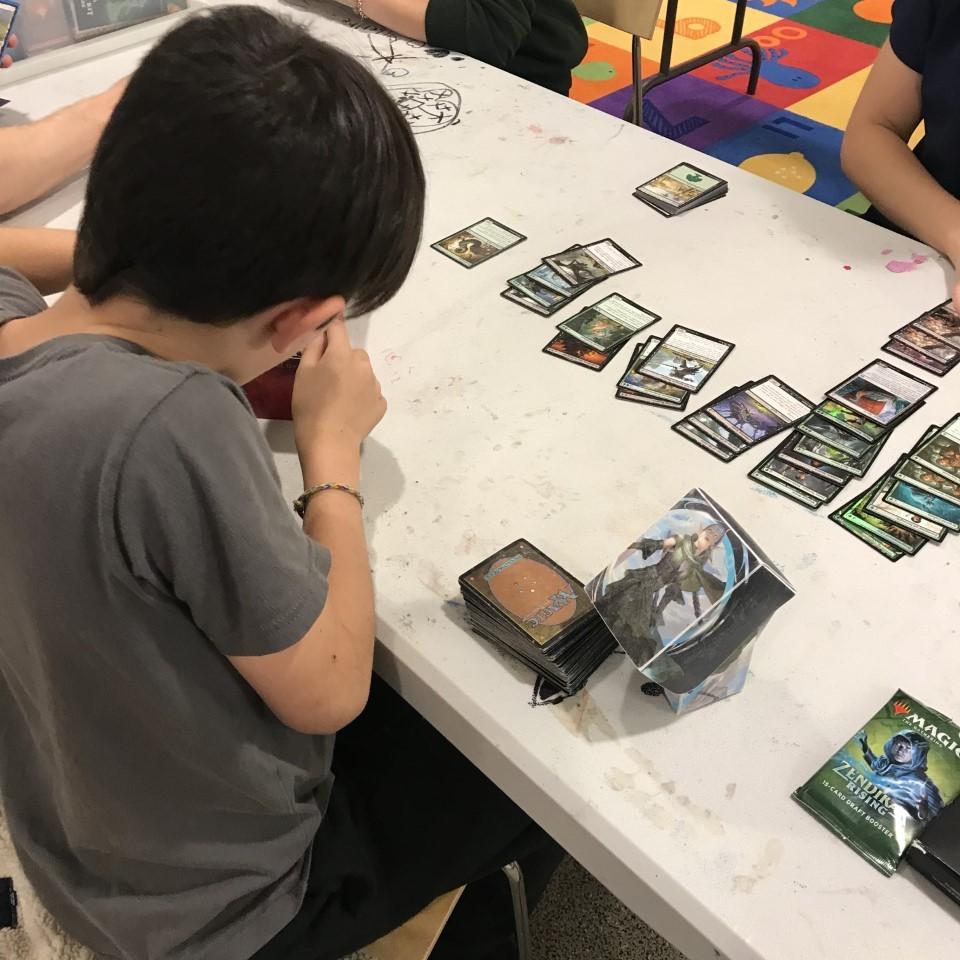 image of kid with Magic card game spread out in front of him