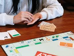 image of people playing the board game Monopoly