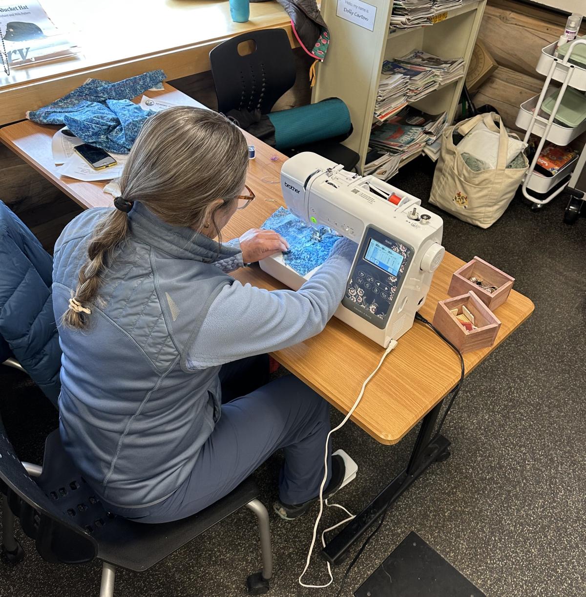 image of woman using a sewing machine